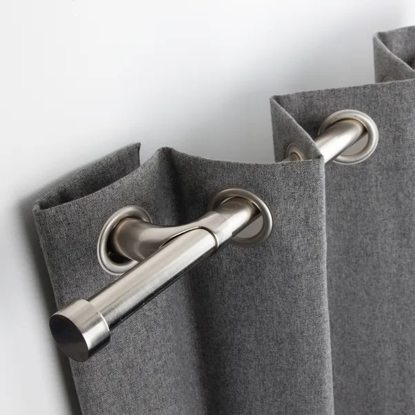 Metal curtain rail fitted with grey curtains